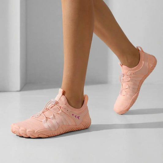 Pink quick-entry walking shoes worn on foot with stretch uppers and adjustable toggle laces