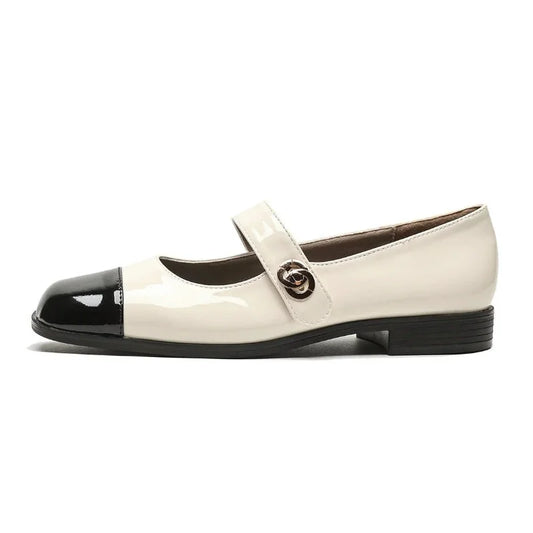 Women's cream and black Mary Jane shoes with an across-foot strap