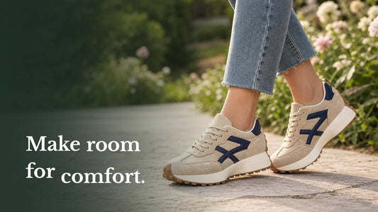 Cream and navy trainers worn outdoors, with the words Make room for comfort