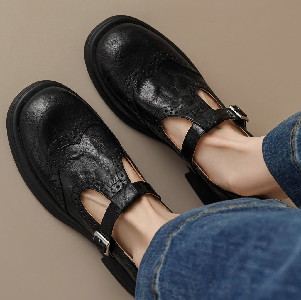 Black women's Mary Jane brogues with T-bar straps and chunky soles, worn with jeans