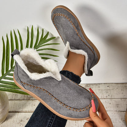 EaseLane women's fleece-lined winter slip-on shoes – grey shoe held to show the lining and sole