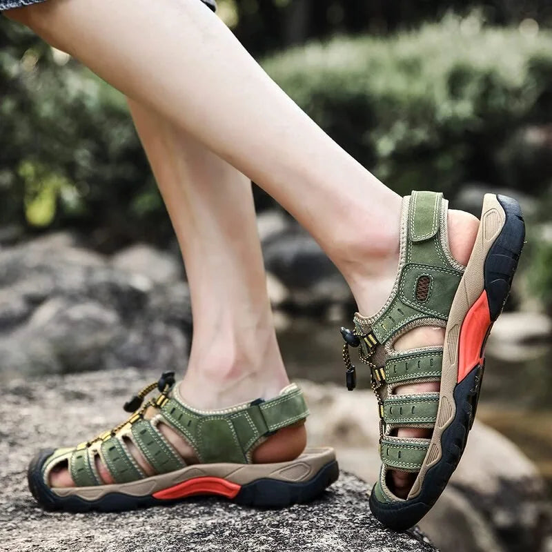 Army green men's outdoor sandals worn on a rocky path