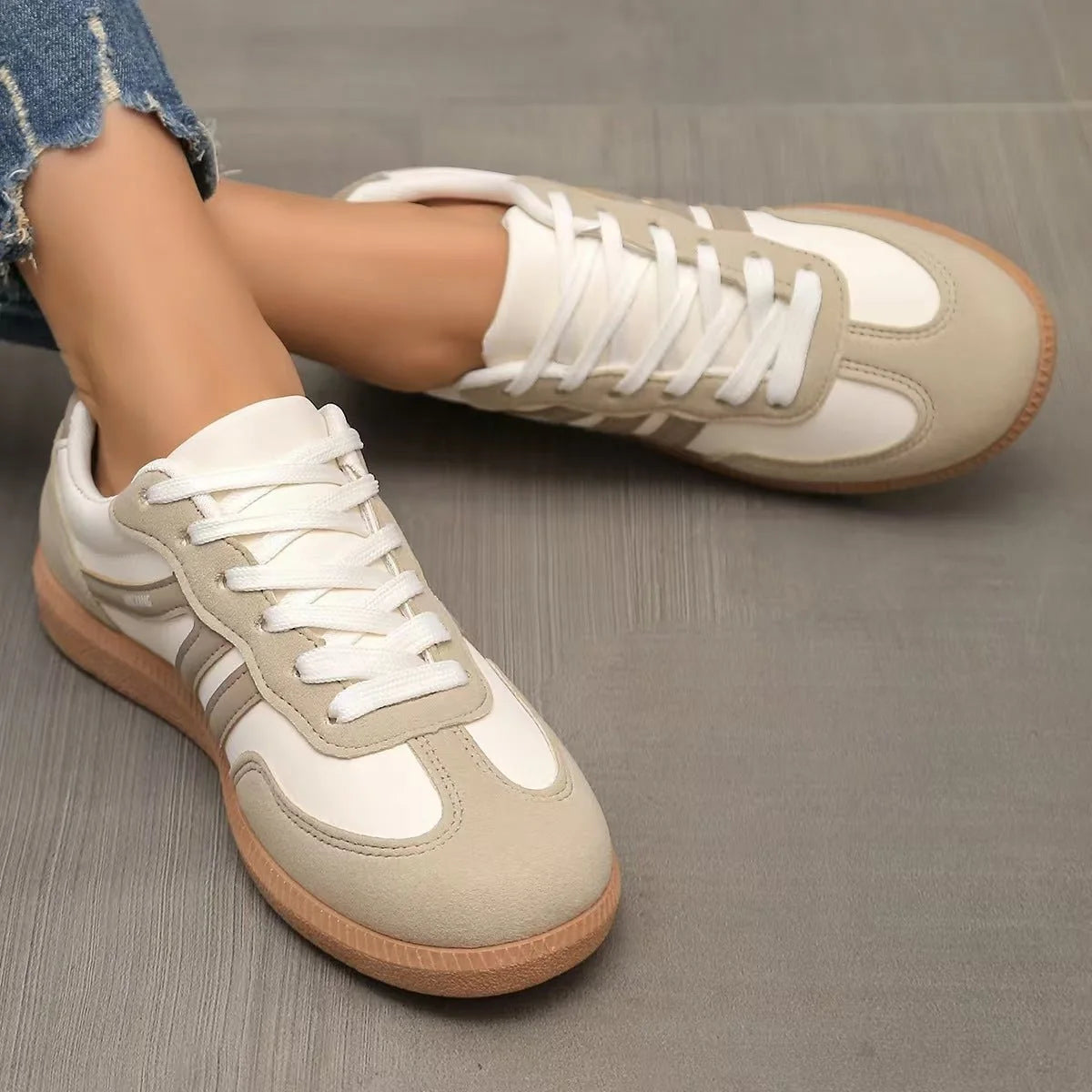 Women's beige and white retro trainers viewed from above