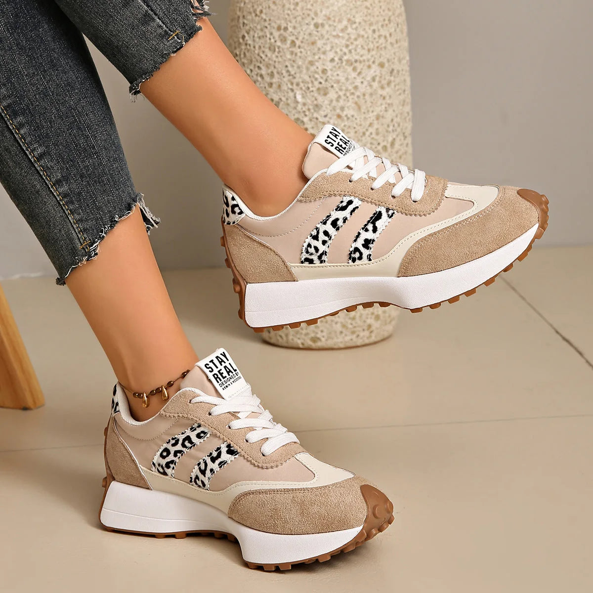 Women's beige and white walking trainers with leopard-print accents, side view
